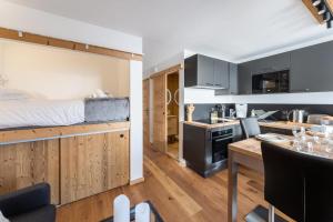 uma cozinha e sala de estar com uma cama num quarto em Résidence OrsiÈre - 2 Pièces pour 4 Personnes 074 em Val Thorens