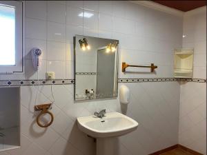 a white bathroom with a sink and a mirror at Casa Rural AGAPITOS 2 in Torre-Pacheco