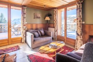 a living room with a couch and a table at Chalet Dauphin - Chalets pour 15 Personnes 264 in LʼHuez
