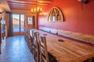 a dining room with a wooden table and chairs at Chalet Dauphin - Chalets pour 15 Personnes 264 in LʼHuez