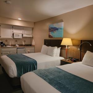 a hotel room with two beds and a kitchen at Old Town Inn in San Diego