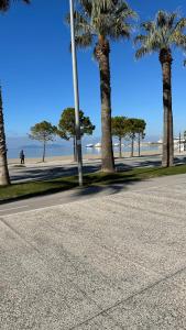 a street with palm trees on the beach at Eno’s Apartment 2 in Vlorë