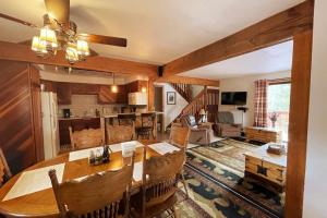 a dining room and living room with a wooden table at Shady Pines- Cozy Mountain Retreat in Idaho Springs
