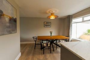 a dining room with a table and chairs and a window at Teach an Choill, Dingle in Dingle