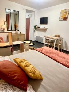 a hotel room with a bed and a living room at L’émeraude - T2 en plein coeur de Dinan in Dinan
