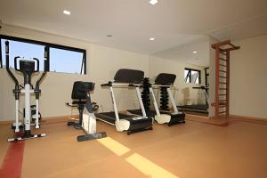 a gym with tread machines and a mirror at Ibirapuera Flat in Sao Paulo