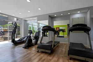 a gym with treadmills and ellipticals in a room at Paulista Premium Flat in Sao Paulo