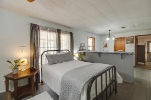a bedroom with a bed and a kitchen at Silver Creek Getaway with Fireplace - 12 Mi to Lake in Prentiss
