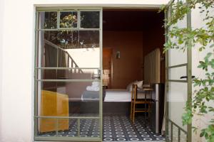 a sliding glass door leading into a bedroom at Casa España in Guadalajara +36 photos