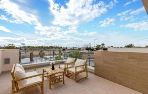 a balcony with chairs and a view of the city at 3 Bedroom Amazing Home In Torre Pacheco in Torre-Pacheco