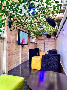 a room with a tv and a table and chairs at Vintage Classic Hotel in Lagos