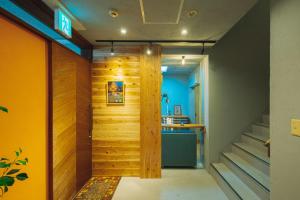 a hallway with a wooden wall and a staircase at Noasobi lodge - Vacation STAY 80823v in Arao