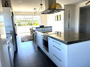 a kitchen with white cabinets and a black counter top at Large and Luxurious at the Lake in Kinloch