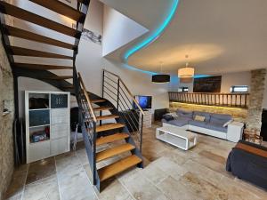 a living room with a spiral staircase in a house at Maison familiale au cœur du D-DAY in Vaux-sur-Aure +46 photos