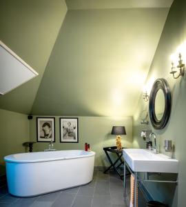 een badkamer met een groot bad en een wastafel bij Quartier-Sud in Antwerpen