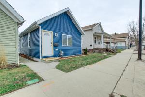 a blue house with a white door on a street at Dog-Friendly Sheboygan Home - 1 Mi to Town! in Sheboygan