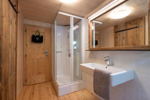 a bathroom with a sink and a shower at Chalet Kasern in Gais