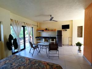 a kitchen and living room with a table and chairs at VILLAS DULCE SUEÑOS RESIDENCIAL in Rincon de Guayabitos