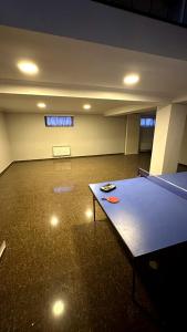 an empty room with a ping pong table in it at Просторный дом в элитном районе Тбилиси in Okrokana