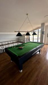 a room with a pool table in a room at Просторный дом в элитном районе Тбилиси in Okrokana