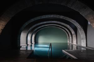 a dark tunnel with water in the middle at NINE DOTS Azorean Art Boutique Hotel in Ponta Delgada