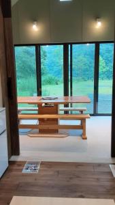 a room with two wooden tables in front of a window at Ayu no Sato Park Campsite - Vacation STAY 42240v in Shōbara