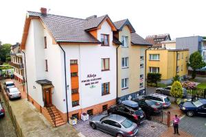 a building with cars parked in a parking lot at Top location Alicja klebba in Władysławowo