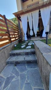a set of stairs leading to a house with white curtains at VillaVittoria in Chia