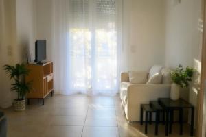 a living room with a white couch and a television at LULIWA in Santarcangelo di Romagna