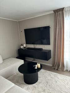 a living room with a couch and a table at Hus med 2 soverom in Sortland +7 photos