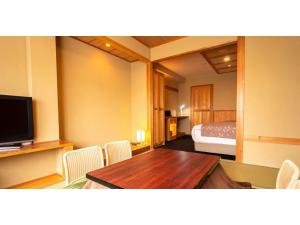 a room with a table and chairs and a bed at Ougatou Hotel - Vacation STAY 32141v in Nagawa