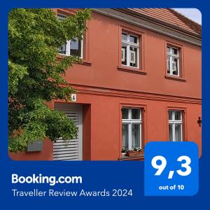 a picture of a red house with the words travel review awards at Omas Linde in Brandenburg an der Havel