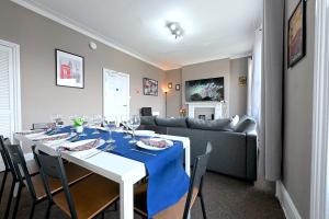 a dining room with a table and a couch at STUNNING 3 Bedroom Serviced Flat IN North London in London