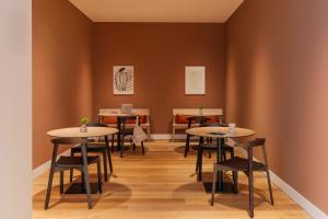 a group of tables and chairs in a room at Sonder Rose in Rotterdam