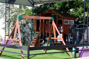 a playground with a slide and a play structure at VILLAS DULCE SUEÑOS RESIDENCIAL in Rincon de Guayabitos