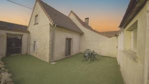 an empty courtyard with two chairs in a building at Escale à Boinville in Prunay-le-Gillon