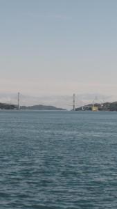 a large body of water with a bridge in the distance at Shimanami Osayo no Yado - Vacation STAY 16166 in Onomichi