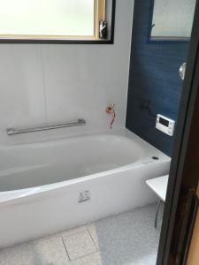 y baño con bañera blanca y espejo. en Shimanami Osayo no Yado - Vacation STAY 16166 en Onomichi