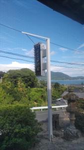 um edifício com um relógio na berma de uma estrada em Shimanami Osayo no Yado - Vacation STAY 16166 em Onomichi