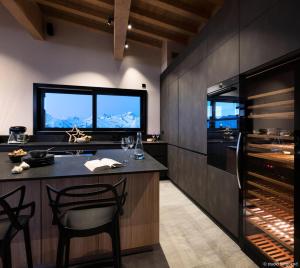 a kitchen with a bar and a wine cellar at Résidence Arc - Chalets 114 in Arc 1800