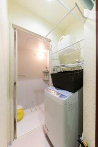 a small kitchen with a refrigerator in a room at Sprinkle inn - Vacation STAY 15784 in Sapporo