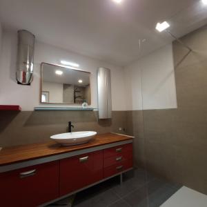 a bathroom with a sink and a mirror at Koča z razgledom in Križe