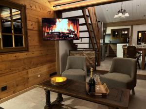 a living room with a fireplace and a tv at Chalet Sarazin - Chalets pour 4 Personnes 994 in Crest-Voland