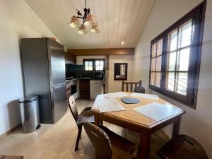 a kitchen with a wooden table and a refrigerator at Chalet Sarazin - Chalets pour 4 Personnes 994 in Crest-Voland