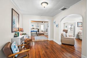 a living room with white walls and wood floors at The River House in Bradenton +46 photos