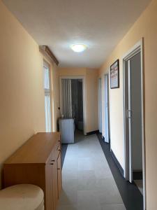 a room with a desk and a hallway with a refrigerator at Kuća SFRJ Šamac 