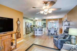 a living room with a flat screen tv and a couch at Auburndale Vacation Rental with Yard and Lake Views in Auburndale