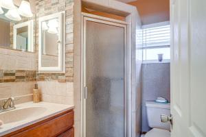 a bathroom with a toilet and a sink and a mirror at Auburndale Vacation Rental with Yard and Lake Views in Auburndale +16 photos