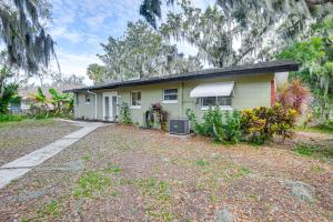 a small yellow house with a yard at Auburndale Vacation Rental with Yard and Lake Views in Auburndale