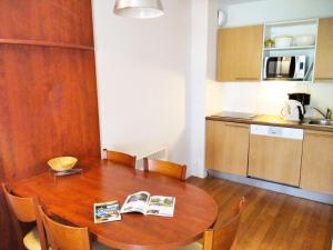 a kitchen with a wooden table with chairs and a dining room at Résidence Pic Du Midi - Apt n°32 - 1er étage - Bâtiment Campan1 MAE-8704 in La Mongie